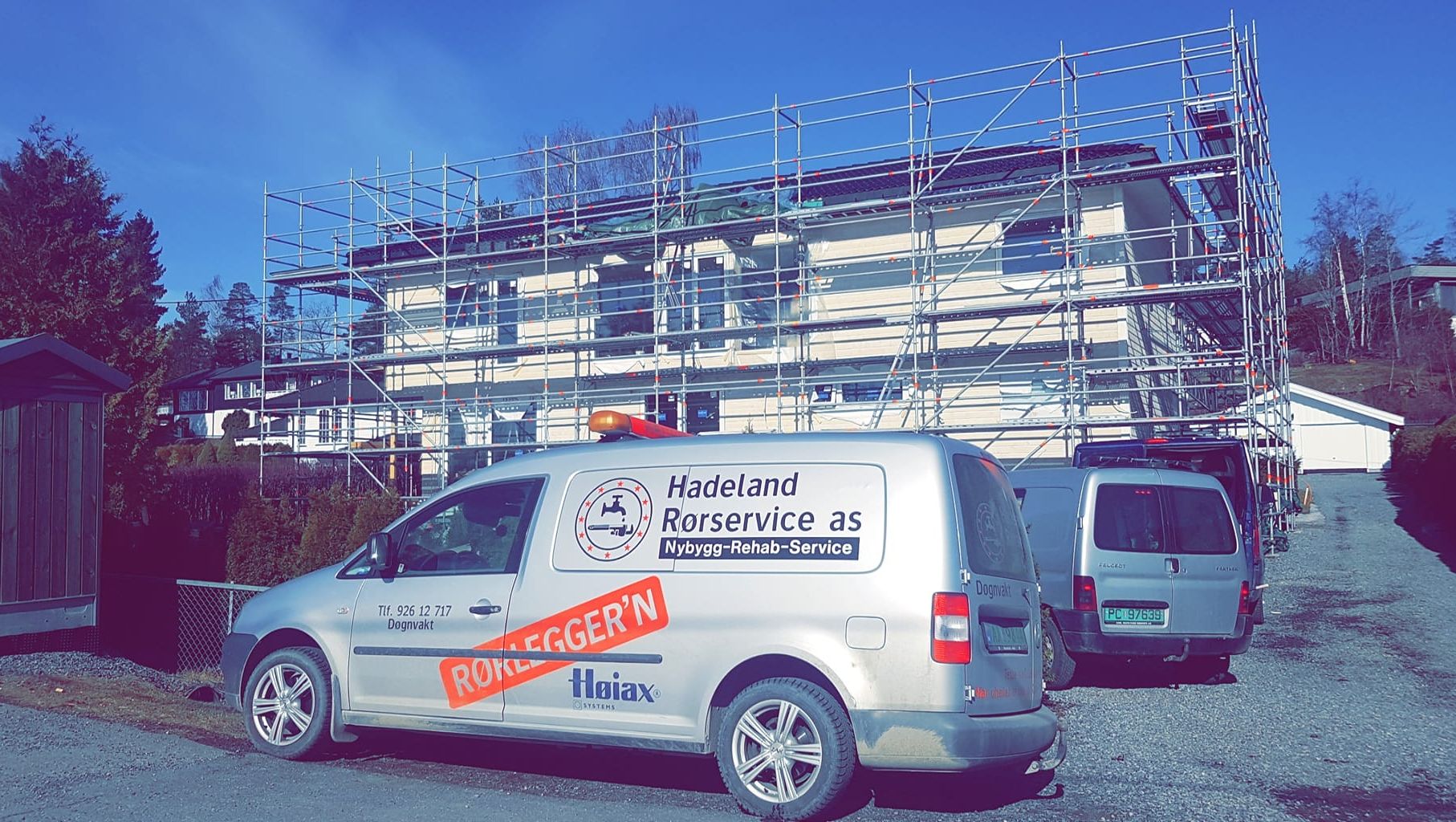 Bil foran bygg under oppussing